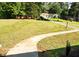 Sprawling front yard with mature trees, a long driveway and sidewalk leading up to the home's entrance at 2751 Colonial Dr, College Park, GA 30337