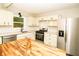 Charming kitchen with white cabinets, stainless steel appliances, and a butcher block island for prep space at 2751 Colonial Dr, College Park, GA 30337