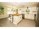 Bright kitchen with an island, stainless steel appliances, and an adjacent dining area at 2751 Colonial Dr, College Park, GA 30337