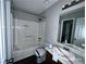 Bathroom with a shower-tub combo and a single sink vanity with an ample sized mirror at 4464 Cary Dr, Snellville, GA 30039