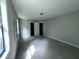 Empty bedroom with neutral gray walls, carpeted floors, a large window, and basic closet at 4464 Cary Dr, Snellville, GA 30039