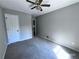 Standard bedroom with carpet, ceiling fan, and large closet at 4464 Cary Dr, Snellville, GA 30039