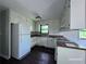 Cozy kitchen with white cabinets, wood countertops, and dark wood flooring at 4464 Cary Dr, Snellville, GA 30039