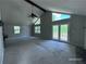 Bright living room with vaulted ceilings, a ceiling fan, large windows, and sliding glass doors to the deck at 4464 Cary Dr, Snellville, GA 30039