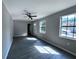 Open living room with gray floors, a ceiling fan, and lots of natural light at 4464 Cary Dr, Snellville, GA 30039
