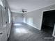 Open living room with gray floors, a ceiling fan, and natural light at 4464 Cary Dr, Snellville, GA 30039