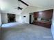 Spacious living room with a stone fireplace, vaulted ceilings, ceiling fan, and open access to the kitchen area at 4464 Cary Dr, Snellville, GA 30039