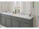 Bathroom features gray cabinets, double sinks, white countertop, and decorative touches at 516 Altamaha Ct, Locust Grove, GA 30248