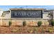Close-up of the River Oaks community entrance sign surrounded by well-kept landscaping at 516 Altamaha Ct, Locust Grove, GA 30248