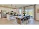 Elegant dining area with stylish seating, modern lighting, and a seamless flow to the kitchen, perfect for gatherings at 516 Altamaha Ct, Locust Grove, GA 30248