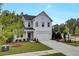 Charming two-story home boasts a manicured lawn, inviting entrance, and a convenient two-car garage at 516 Altamaha Ct, Locust Grove, GA 30248