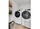Featuring modern front load washer and dryer set, the well-lit laundry room offers convenience and efficiency at 516 Altamaha Ct, Locust Grove, GA 30248
