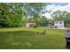 Expansive backyard featuring a well-kept lawn, a storage shed, and ample space for outdoor activities at 405 Emory St, Oxford, GA 30054