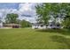 Spacious backyard with a lush lawn, mature trees, and plenty of room for outdoor enjoyment at 405 Emory St, Oxford, GA 30054