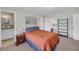 Well-lit bedroom showing a comfortable bed, adjoining bathroom and black metal shelf at 405 Emory St, Oxford, GA 30054