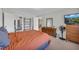 View of the bedroom displaying a large bed, dresser, and doorway leading to another room at 405 Emory St, Oxford, GA 30054