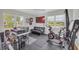 Bright home gym features two large windows and workout equipment including exercise bike and rower at 405 Emory St, Oxford, GA 30054