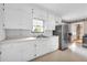Spacious kitchen offering ample countertop space, white cabinets and stainless-steel refrigerator at 405 Emory St, Oxford, GA 30054