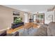 Cozy living room with hardwood floors, complemented by neutral walls and ceiling fan, and a view into the dining area at 405 Emory St, Oxford, GA 30054