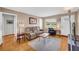 Comfortable living room featuring hardwood floors, neutral paint, and ample natural light from the large window at 405 Emory St, Oxford, GA 30054
