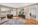 Bright living room with a large front window, complemented by neutral walls and hardwood floors at 405 Emory St, Oxford, GA 30054