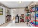 View of walk-in pantry with shelving, mini fridge, storage containers and vintage wallpaper at 405 Emory St, Oxford, GA 30054