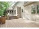Spacious wooden deck with stairs leading to a screened porch and backyard, perfect for outdoor enjoyment at 5065 Hickory Hills Dr, Woodstock, GA 30188