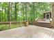 Expansive wooden deck overlooking a lush, green backyard with mature trees, perfect for outdoor living at 5065 Hickory Hills Dr, Woodstock, GA 30188