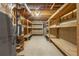 Unfinished basement with exposed utilities and wooden shelving for ample storage space at 5065 Hickory Hills Dr, Woodstock, GA 30188