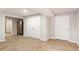 Finished basement with tile flooring, closet doors and access to other areas at 5065 Hickory Hills Dr, Woodstock, GA 30188