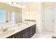 Bathroom featuring double vanity with dark cabinets, soaking tub, and shower at 5065 Hickory Hills Dr, Woodstock, GA 30188