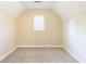 Attic bedroom with a window, carpet flooring and added shelving storage at 5065 Hickory Hills Dr, Woodstock, GA 30188