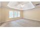 Large bedroom featuring tray ceiling, plush carpet, and great natural light at 5065 Hickory Hills Dr, Woodstock, GA 30188