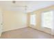 Bright bedroom with neutral walls, two windows, and a ceiling fan for added comfort at 5065 Hickory Hills Dr, Woodstock, GA 30188