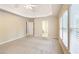 Large bedroom featuring tray ceiling, plush carpet, and multiple windows at 5065 Hickory Hills Dr, Woodstock, GA 30188