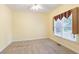 Cozy bedroom with neutral carpet, window, and ample natural light at 5065 Hickory Hills Dr, Woodstock, GA 30188