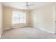 A bright bedroom with carpet flooring, a ceiling fan and a window for natural light at 5065 Hickory Hills Dr, Woodstock, GA 30188