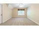 A carpeted bedroom with a window to let in plenty of natural light and fresh air at 5065 Hickory Hills Dr, Woodstock, GA 30188