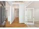 Inviting foyer with hardwood floors, white trim, and a view into multiple rooms creating an airy open concept at 5065 Hickory Hills Dr, Woodstock, GA 30188