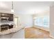 Bright kitchen area showcasing granite countertops, stainless appliances, hardwood floors, and open breakfast area at 5065 Hickory Hills Dr, Woodstock, GA 30188