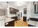 Well-appointed kitchen with granite countertops, stainless steel appliances, dark cabinets, and hardwood flooring at 5065 Hickory Hills Dr, Woodstock, GA 30188