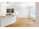 Open kitchen and dining area with hardwood floors and granite countertop at 5065 Hickory Hills Dr, Woodstock, GA 30188