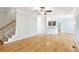 Spacious living room with hardwood floors open to kitchen and stairs at 5065 Hickory Hills Dr, Woodstock, GA 30188