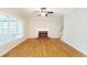 Bright living room with fireplace, hardwood floors, and large windows at 5065 Hickory Hills Dr, Woodstock, GA 30188