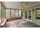 Enclosed porch with brick flooring and many windows providing natural light and backyard views at 5065 Hickory Hills Dr, Woodstock, GA 30188