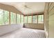 Enclosed sunroom with lots of natural light and views of the surrounding woods at 5065 Hickory Hills Dr, Woodstock, GA 30188