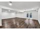 Finished basement has wood flooring, recessed lighting, and access to backyard at 529 Greystone Trl, Marietta, GA 30068