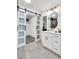 The bathroom has a bright white vanity and gray floor tile with open access to closet at 529 Greystone Trl, Marietta, GA 30068