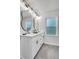 Bright bathroom features a double sink vanity, modern fixtures, and stylish wavy mirrors at 529 Greystone Trl, Marietta, GA 30068