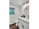 Well-lit bathroom featuring a modern vanity with storage, round mirror, and stylish gold fixtures at 529 Greystone Trl, Marietta, GA 30068